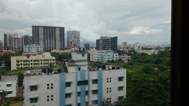 Buildings in city against cloudy sky