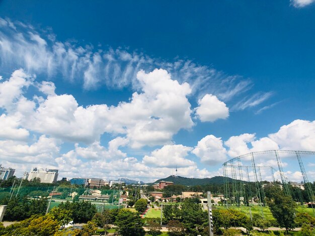 Buildings in city against cloudy sky