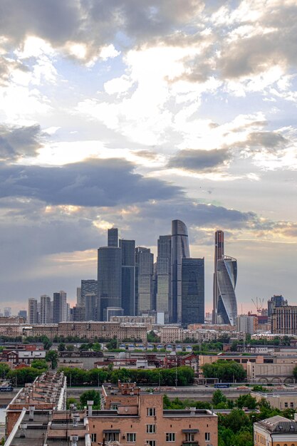 Buildings in city against cloudy sky