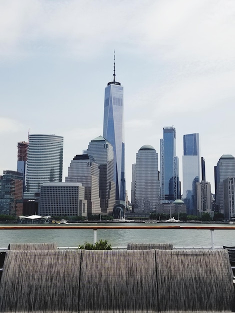 Buildings in city against cloudy sky