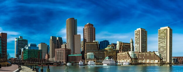 Buildings in city against cloudy sky