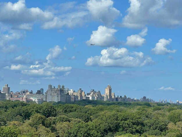 Buildings in city against cloudy sky