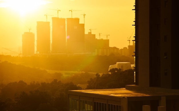 Photo buildings in city against sky during sunset