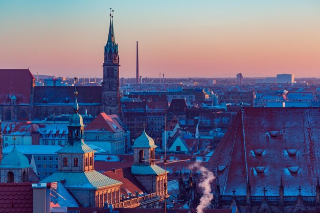 Buildings in city against sky during sunset