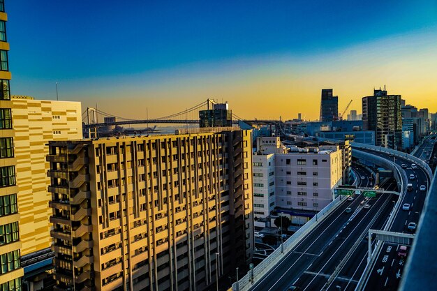 Buildings in city against sky during sunset