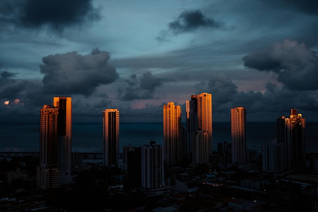 Buildings in city against sky at dusk