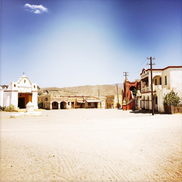 Buildings at desert against sky