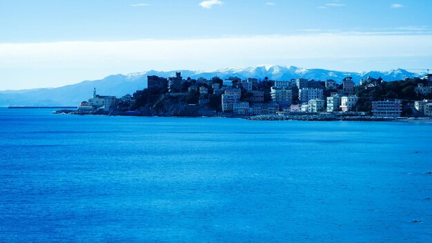 Buildings in distance with calm blue waterfront