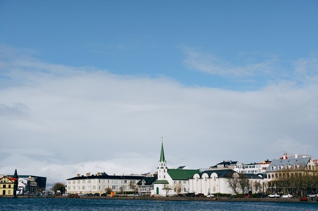 Buildings on the shore of lake tjodnin in reykjavik the capital of iceland