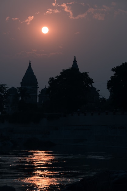 Buildings silhouette at sunset in India.