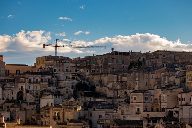 Buildings in town against cloudy sky