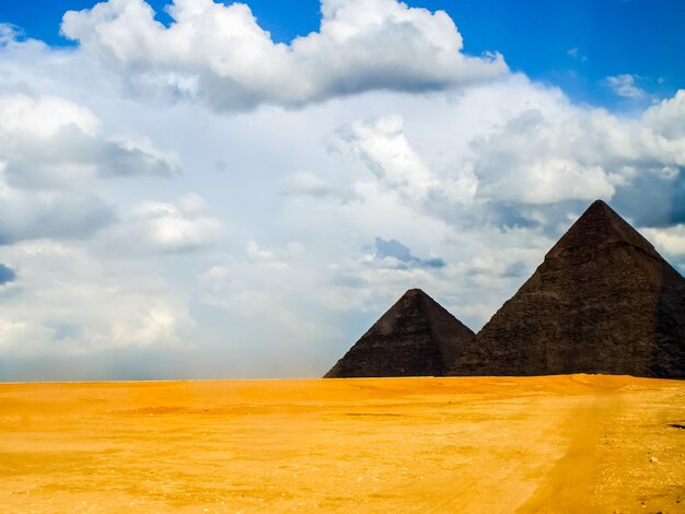 Built structure on desert against cloudy sky