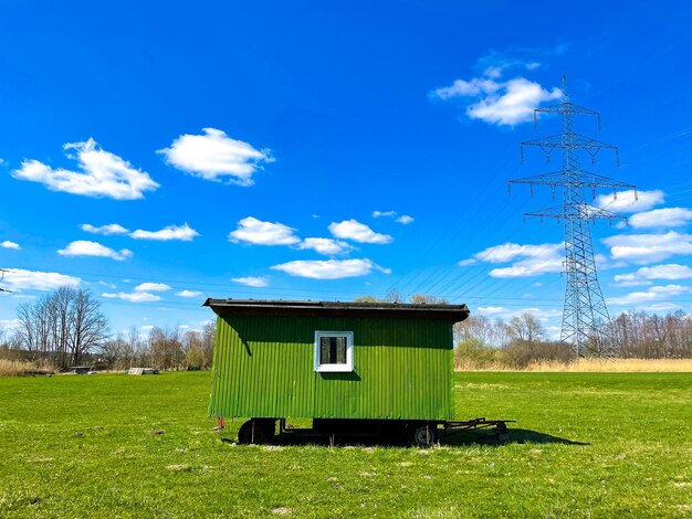 Built structure on field against blue sky