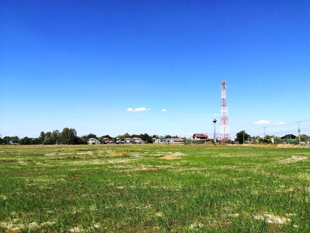 Built structure on field against clear blue sky