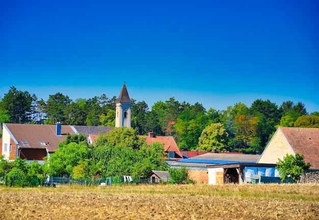 Built structure on field against clear blue sky