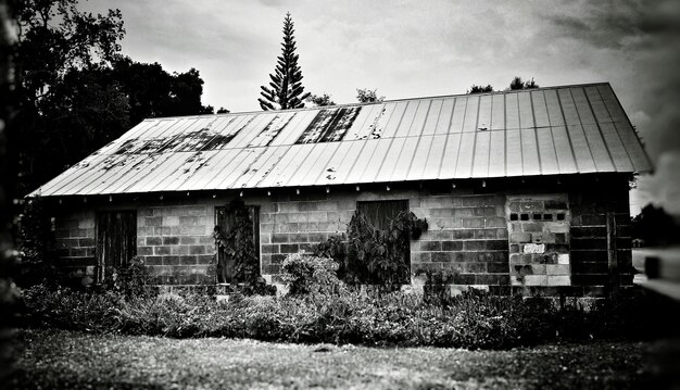 Built structure on field against cloudy sky