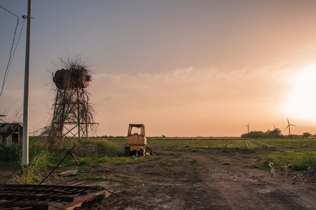 Built structure on field against sky during sunset