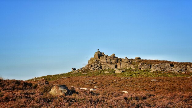 Built structure on land against clear blue sky