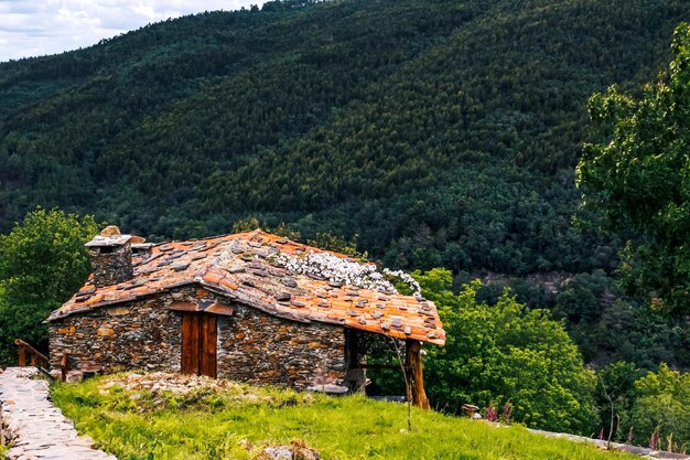 Photo built structure on land by trees on mountain