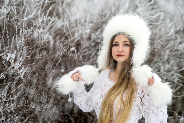 Buiten mode portret van mooie jonge vrouw in winter woud