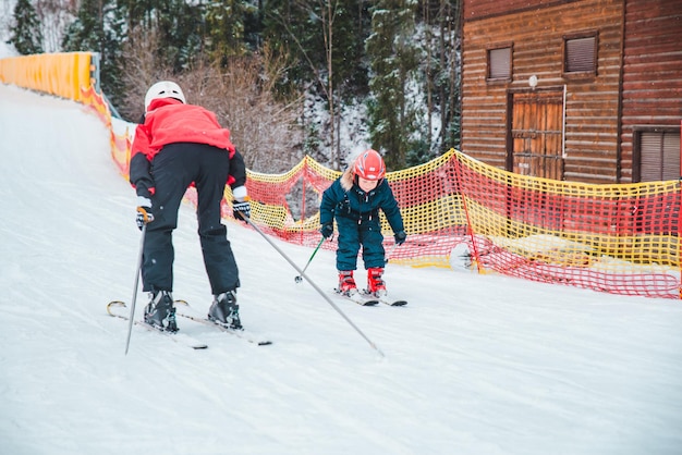 BUKOVEL, UKRAINE - December 9, 2018: little kid skiing at snowed hill by him self. winter sport activity