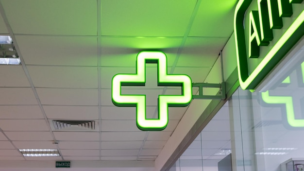 Photo bulb green cross indoor closeup pharmacy pointer