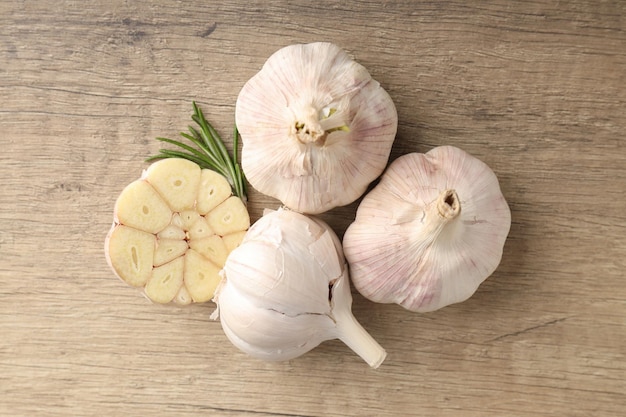Bulbs of garlic on wooden background close up