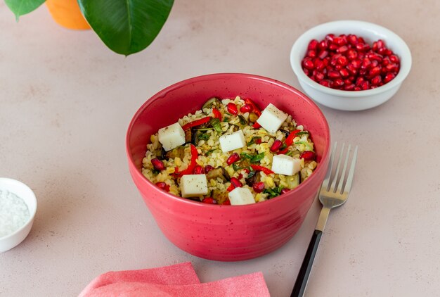 Bulgur with cheese, pepper, eggplant and pomegranate.