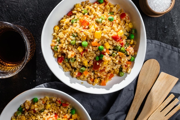 Bulgur with vegetables in a white plate close-up