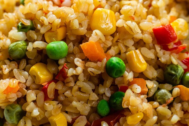 Bulgur with vegetables in a white plate close-up