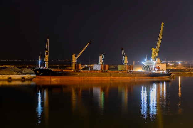 Балкер пришвартовался у причала в порту. Ночной вид. Bulker. Сухогруз.