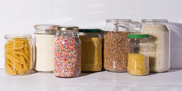 Bulk products in zero waste shop. cereal and candies in glass jars on shelves. Eco friendly shopping in plastic free grocery store.