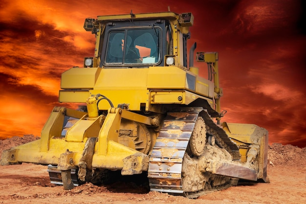 Bulldozer machine is leveling construction site earthmover with sunset sky closeup construction heavy machinery