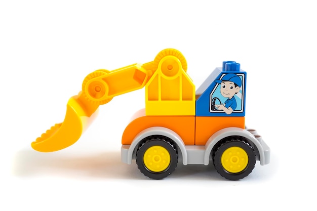 Bulldozer plastic toy with orange universal blade isolated on white