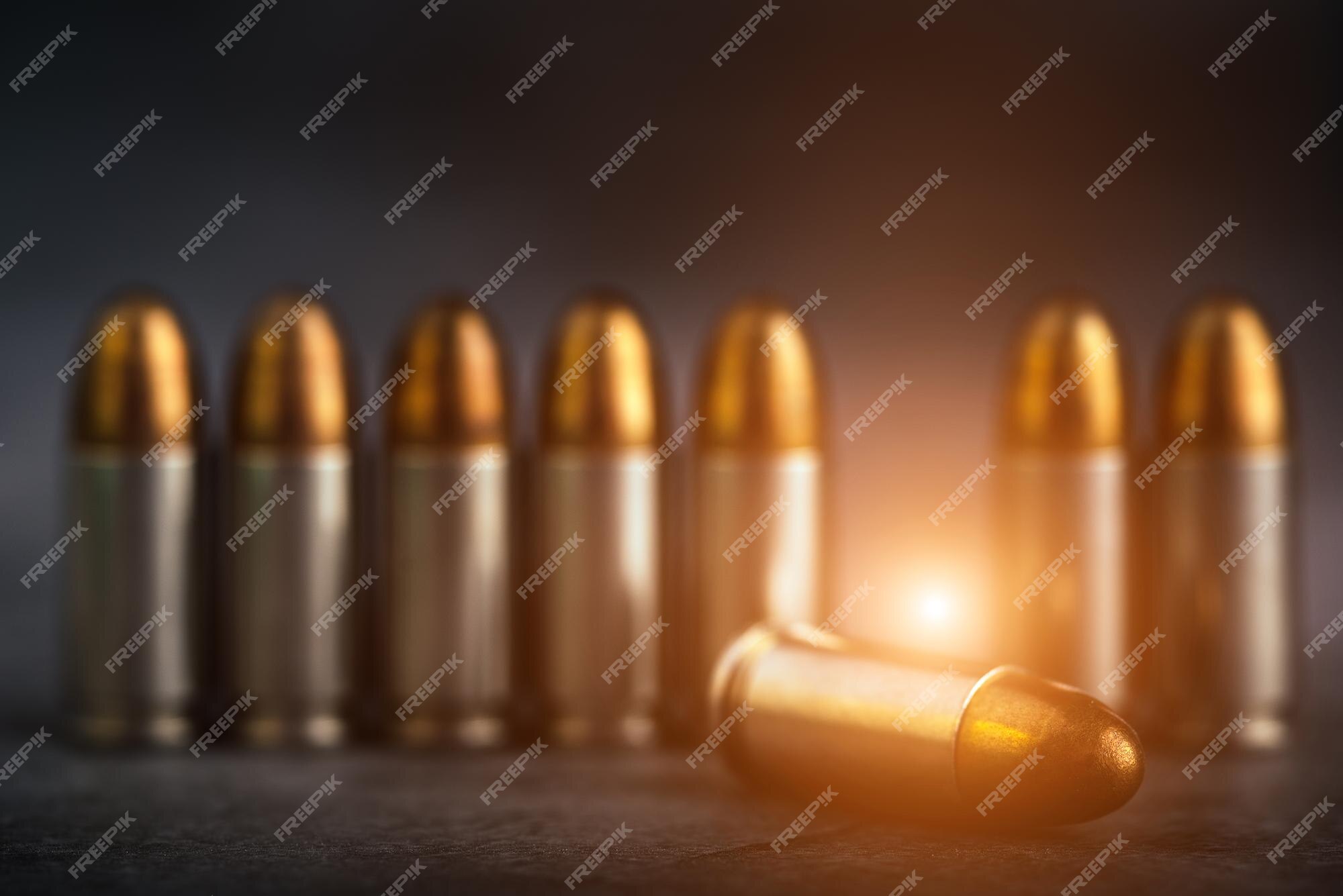 Premium Photo | Bullet 9mm. on the dark stone and military technology. Premium Photo | Bullet 9mm. on the dark stone and military technology.