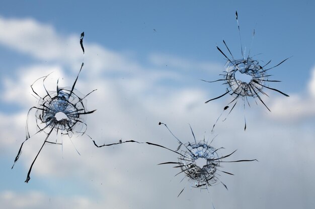 Photo bullet hole in dirty glass on a white background.