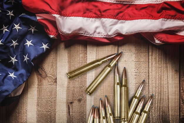 Bullets with an USA flag on a black wood background