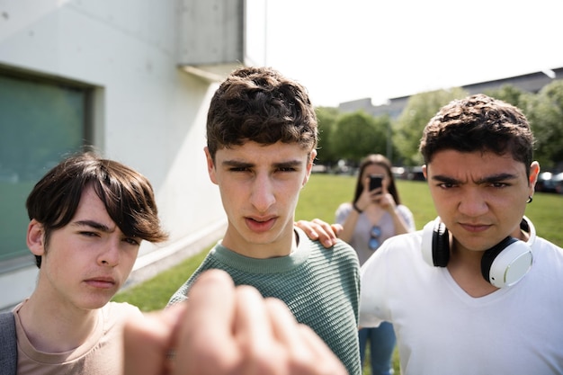 Photo bullied view of aggressive friends menacing