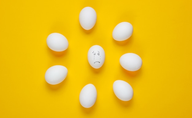 Bullying concept with eggs. top view, minimalism