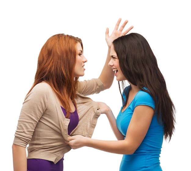 bullying, friendship and people concept - two teenagers having a fight and getting physical