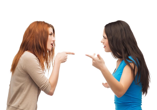 bullying, friendship and people concept - two teenagers having a fight