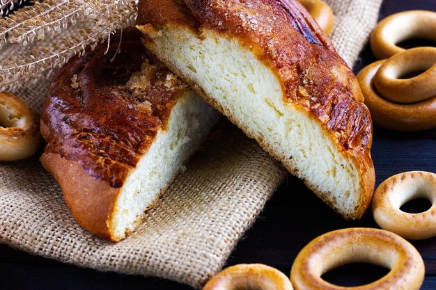 A bun a bagel on a dark wooden background bakery counter