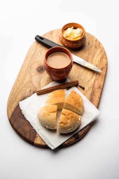 Bun-maska Tea or bun Maska chai combo features a slightly sweet bun studded with raisins that is cut into half and laden with wholesome butter, Mumbai food