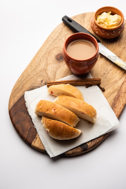 Bun-maska Tea or bun Maska chai combo features a slightly sweet bun studded with raisins that is cut into half and laden with wholesome butter, Mumbai food