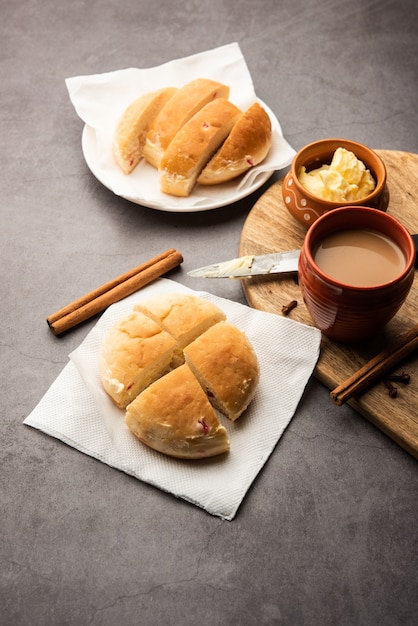 Bun-maska Tea or bun Maska chai combo features a slightly sweet bun studded with raisins that is cut into half and laden with wholesome butter, Mumbai food