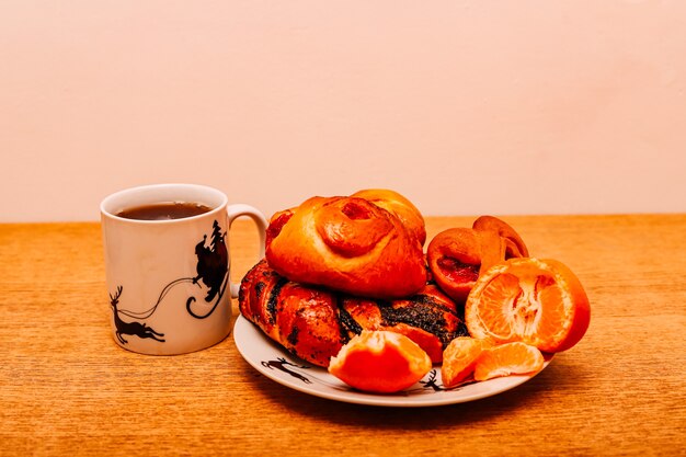 A bun with poppy seeds on a Christmas table on a white plate with deer