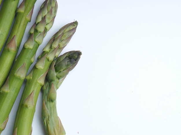 A bunch of asparagus is on a white background.