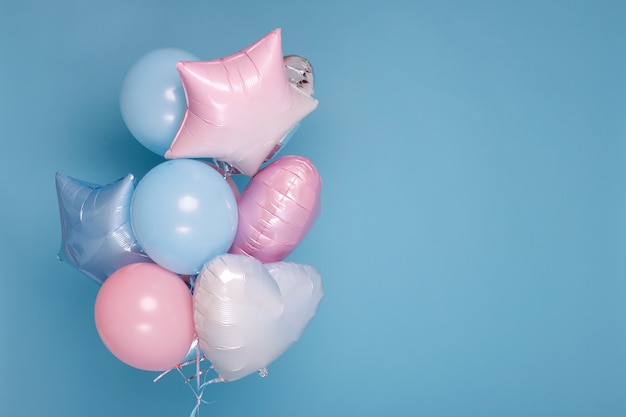 A bunch of balloons on a blue surface