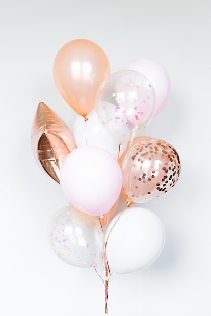 Bunch of balls in white and pink colors on a light background