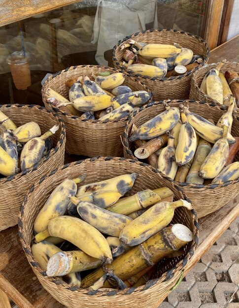 A bunch of bananas are in baskets on display.